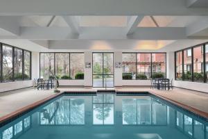 a pool with chairs and windows in a building at Homewood Suites Williamsburg in Williamsburg