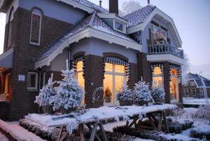 a house with snow on the front of it at Villa Rose in Bergum