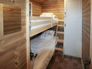 a bedroom with two bunk beds in a wooden cabin at Treehouse Cabin in Westward +4 photos