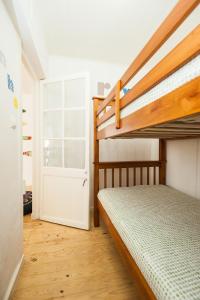 a bedroom with two bunk beds and a door at Castelo Terrace in Lisbon +17 photos