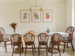 a dining room with a table and chairs at West Skeroblin in Campbeltown