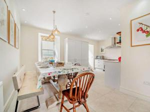 a kitchen and dining room with a table and chairs at West Skeroblin in Campbeltown
