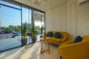 a living room with a yellow couch and a table at Hotel Tranquil Airport Road Sector 66 Mohali Chandigarh in Mohali