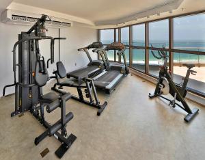 a gym with two treadmills and two exercise bikes at Arena Leme Hotel in Rio de Janeiro
