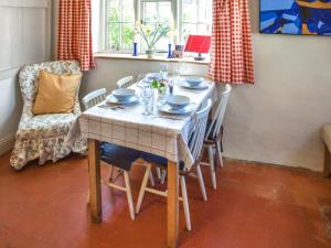 a dining room table with chairs and a white table cloth at The Buttery in Buxton