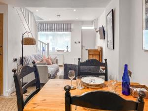 a dining room with a table with wine glasses on it at Ernies in Haverigg
