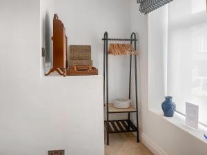 a room with a shelf with baskets on it at Ernies in Haverigg