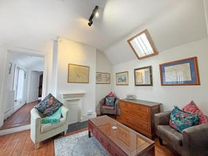 a living room with a couch and a table at The Courtyard Cottage in Llangollen
