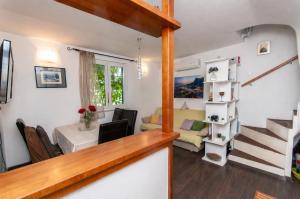 a living room and dining room with a staircase and a living room at Holiday House Therapy in Omiš