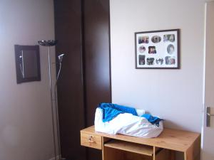 a room with a refrigerator and a wooden table at Chambre lit simple in Saint-Herblain