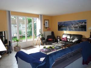 a living room with a couch and a table at Chambre lit simple in Saint-Herblain