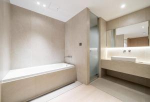 a bathroom with a tub and a sink and a mirror at 서초 Hotel Brick in Seoul