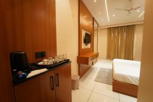 a hotel room with a bed and a bathroom at Hotel the republic in Zirakpur