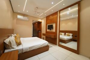 a hotel room with a bed and a mirror at Hotel the republic in Zirakpur