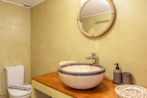 a bathroom with a sink and a mirror at Hippocrates' House in Amorgos +20 photos