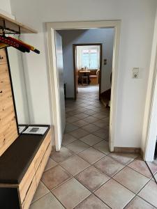 a hallway with a room with a tile floor at Stadthaus mit traditionellem Flair in Wels
