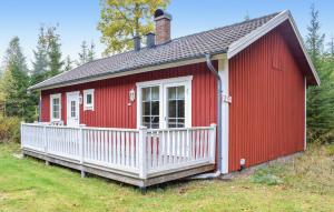 a red tiny house with a white porch at Stunning Home In Eksjö With Kitchen in Eksjö