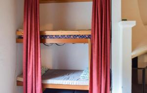 a room with bunk beds with a red curtain at Stunning Home In Eksjö With Kitchen in Eksjö +5 photos