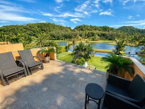 a patio with chairs and a view of a lake at Royal Shell by Utalay Koh Chang in Ban Khlong Son