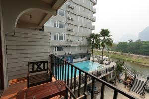 a balcony view of a hotel with a swimming pool at The Elephant Crossing Hotel in Vang Vieng