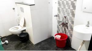 a small bathroom with a toilet and a sink at Royal shades kodihali in Bangalore +32 photos