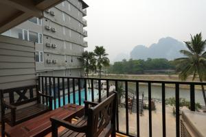 a balcony of a building with a swimming pool at The Elephant Crossing Hotel in Vang Vieng