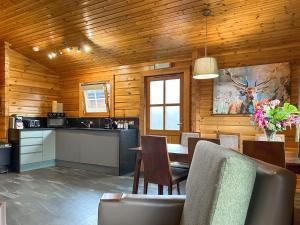 a kitchen and dining room with a table and chairs at Lodge 3 - Uk51250 in Glasgow