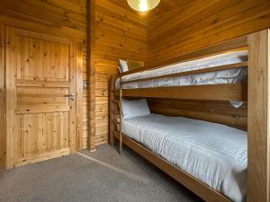 a bedroom with two bunk beds in a log cabin at Lodge 3 - Uk51250 in Glasgow +6 photos