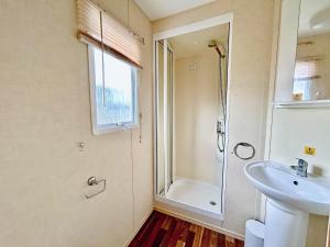 a bathroom with a shower and a sink at The Medway - Uk51004 in Eastchurch +3 photos