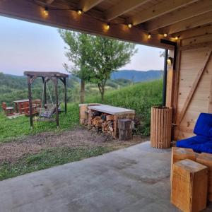 a pavilion with a table and a picnic table and a bench at Bellevue wooden apartment in Žetale
