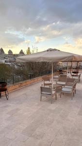 a group of benches sitting under a large umbrella at Nature Park Cave Hotel in Göreme