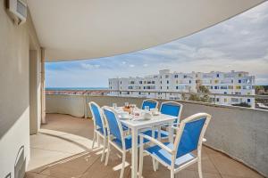 a table and chairs on a balcony with a view at Résidence Odalys Le Lotus Blanc in Le Barcarès
