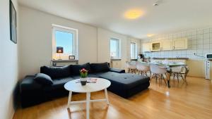 a living room with a couch and a table at CBlue "Admiralsloge - Nauticus" in Warnemünde