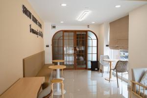 a restaurant with stools and tables in a room at SNOW HOUSE Buriram in Buriram +80 photos