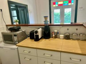 a kitchen with a counter top with a microwave at Levendulásház Palkonya in Palkonya
