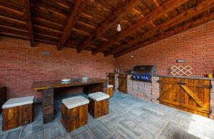a kitchen with a table and a counter with stools at Wellness Vila Žakovce s bazénom in Veľká Lomnica +51 photos