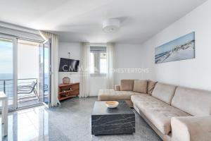 a living room with a couch and a table at Blue Seacliff Luxe in Komoševina