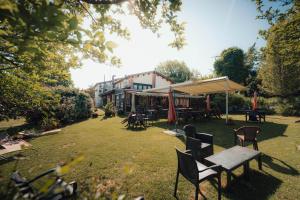a yard with chairs and tables and a tent at Agriturismo La Marletta in Imola