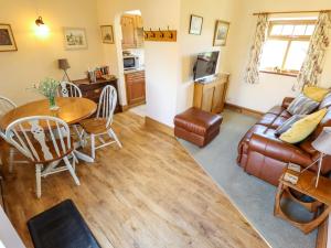 a living room with a table and a couch at Ticklepenny in Louth