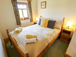 a bedroom with a bed with towels on it at Ticklepenny in Louth