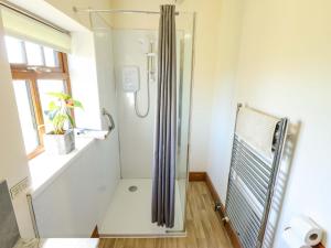 a shower with a glass door in a bathroom at Ticklepenny in Louth +25 photos