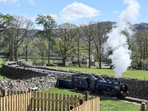 a steam train is traveling down the tracks at Dakota in Holmrook