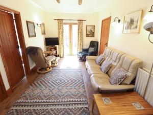 a living room with a couch and a table at Kingfisher in Louth