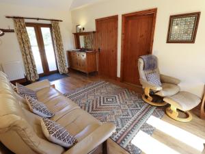a living room with a couch and a chair at Kingfisher in Louth