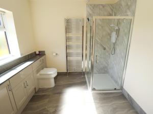 a bathroom with a shower and a toilet at Kingfisher in Louth +21 photos