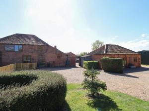 two brick buildings with bushes in a yard at Kingfisher in Louth
