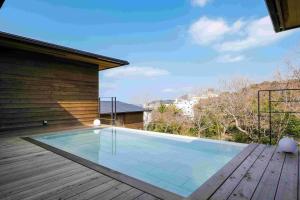 a swimming pool on the deck of a house at Kisara Oneness in Toba