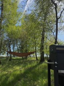 a hammock in a park next to a trash can at Ostrov klidu - posed - sauna in Hradešín