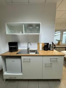 a kitchen with a sink and a counter at Ecke's Apartment in Hüllhorst