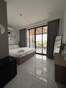 a bedroom with a bed and a view of a patio at SQUIRRELHOME District8 in Ho Chi Minh City